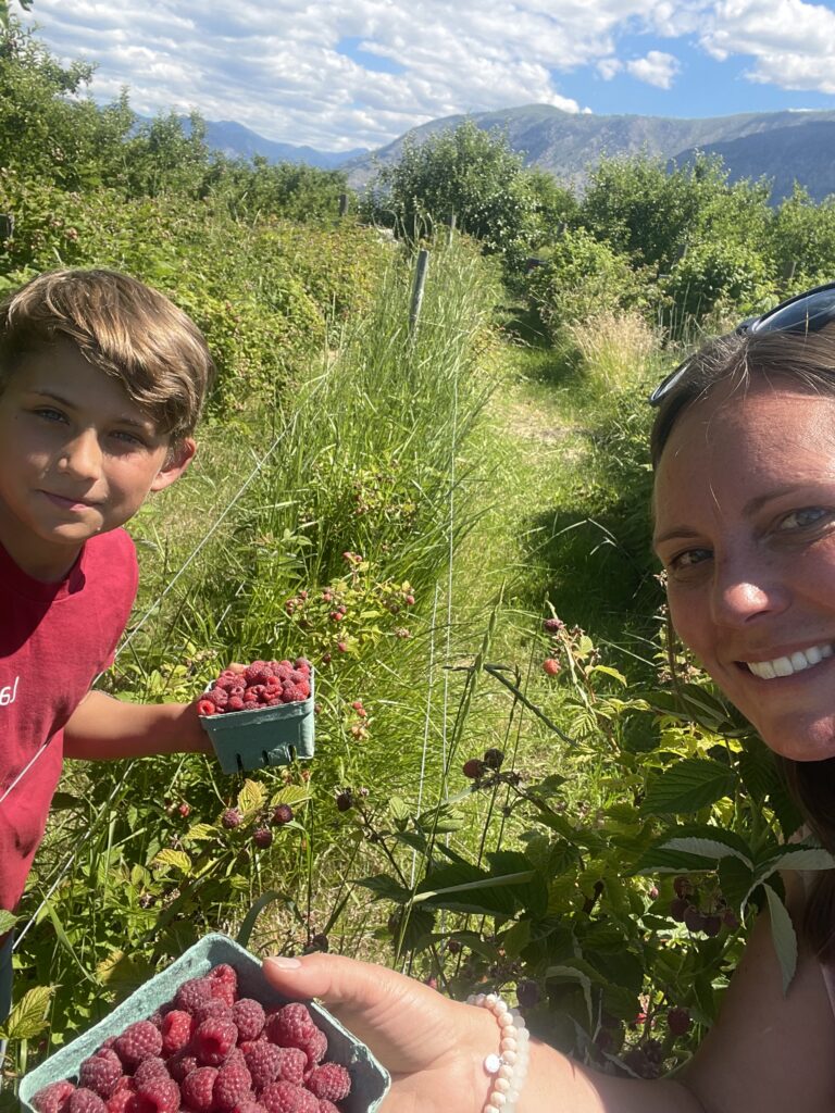 Owen and Jeana over the hump with the first ripe raspberries at Chelan Valley Farms