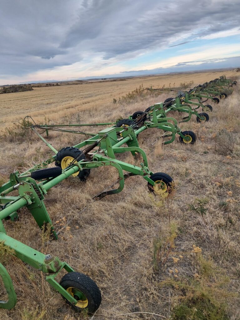 A rod weeder and grain drill parked beside a wheat field on the road to Ephrata, Washington